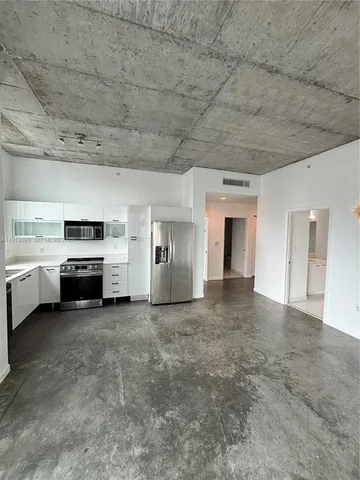 a view of a livingroom with a kitchen