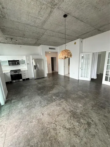 a view of a livingroom with furniture window and a ceiling fan