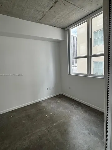 an empty room with a empty space and windows