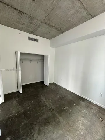a view of a livingroom with wooden wall and closet