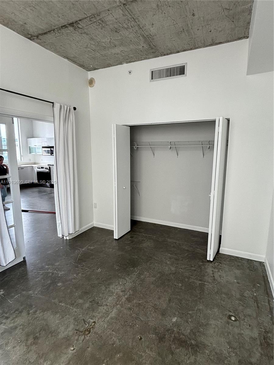133 Northeast 2nd Avenue, Unit 1519 Miami, FL 33132 - Photo 10 of 41 a view of a livingroom with wooden wall and closet