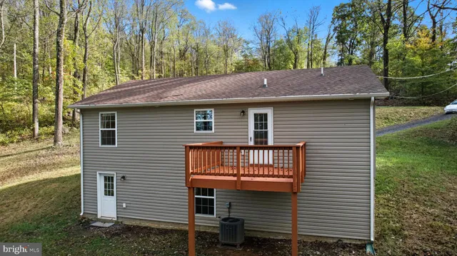 a view of a house with a yard and tree s