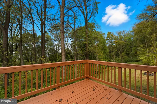 a view of balcony with wooden floor and fence
