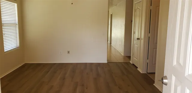 a view of a room with wooden floor