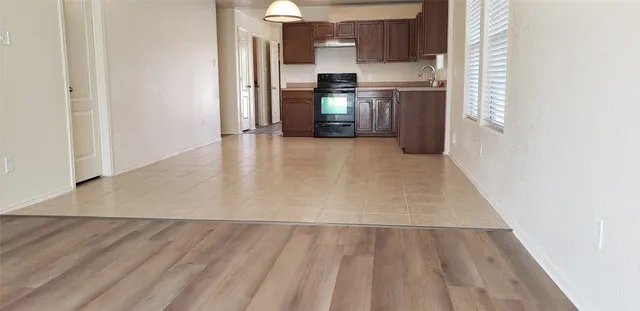 a view of a kitchen with a sink and a refrigerator