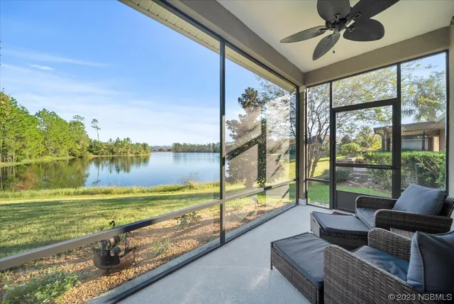 a view of a living room and floor to ceiling window and an ocean view