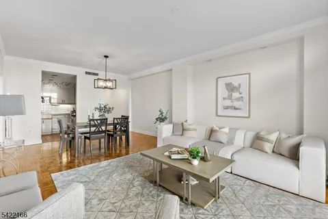 a living room with furniture and view of kitchen