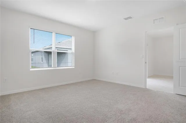 a view of empty room with windows