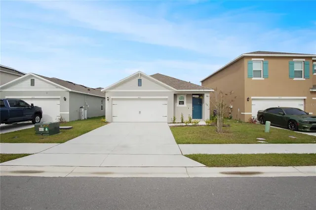 a front view of a house with a yard and garage