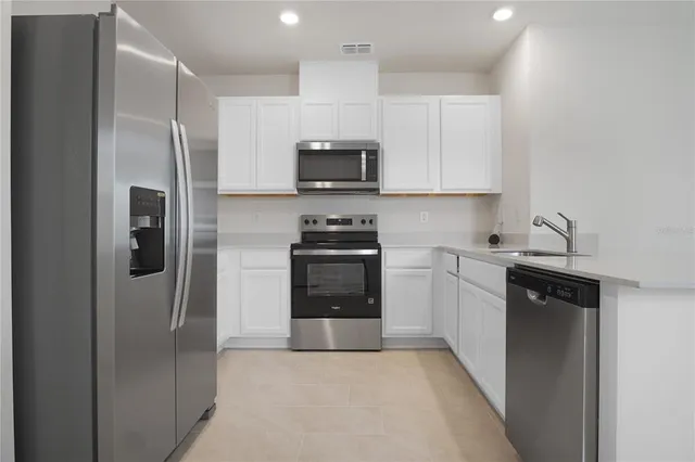 a kitchen with a refrigerator sink and stove