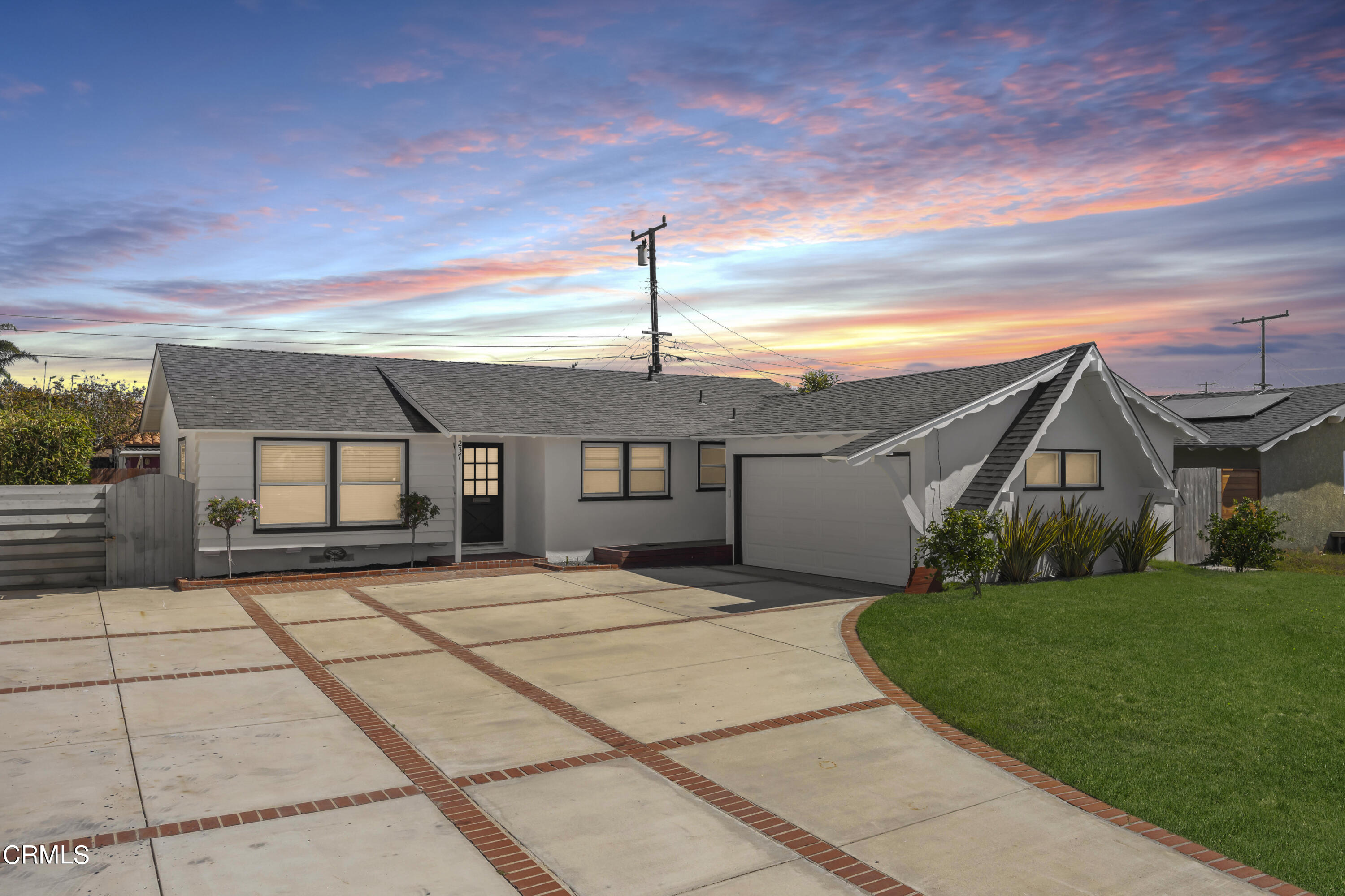 237 Brucker Road West Oxnard, CA 93033 - Photo 1 of 29 a front view of a house with a yard and garage