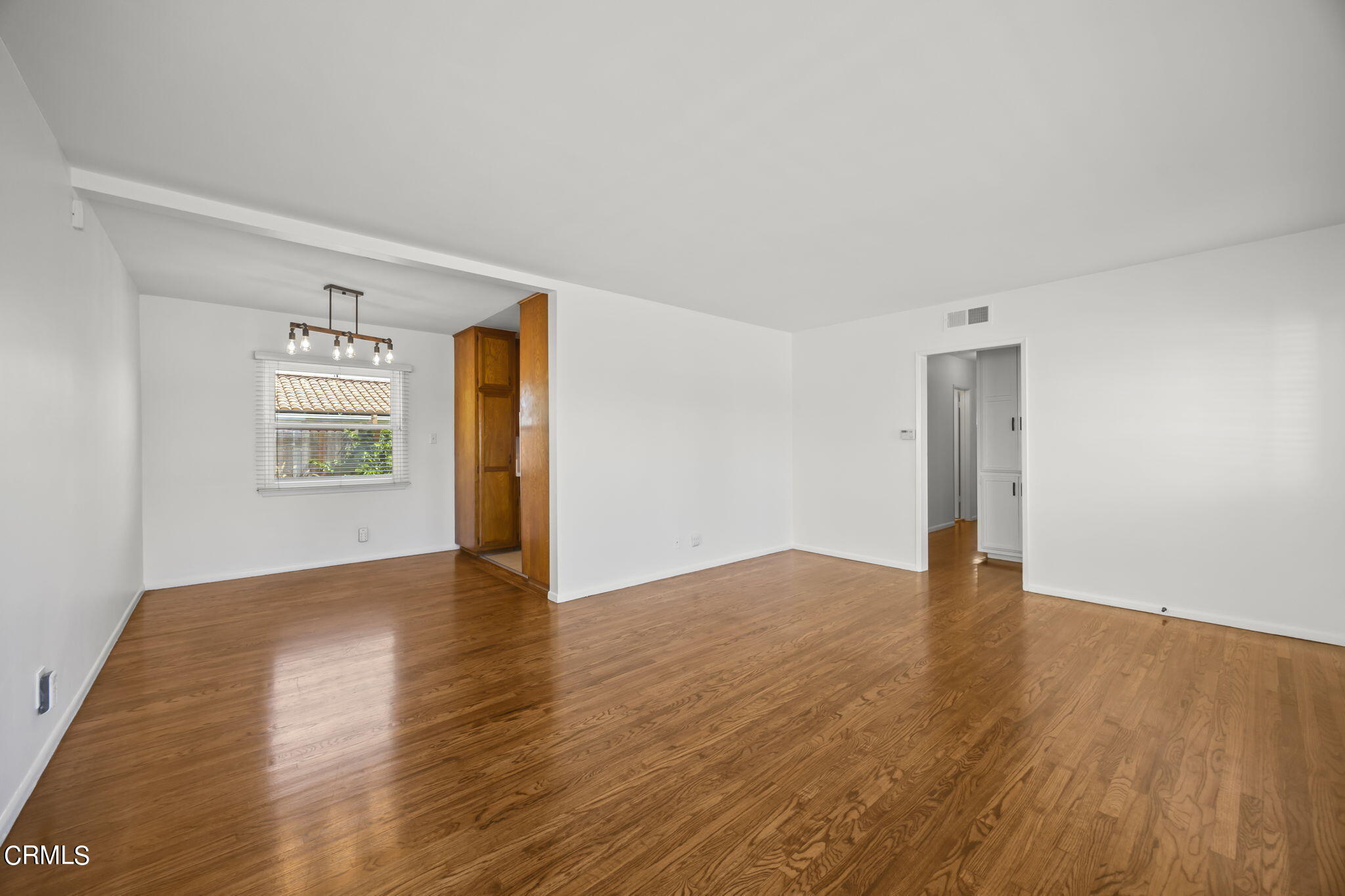 237 Brucker Road West Oxnard, CA 93033 - Photo 11 of 29 a view of an empty room with wooden floor and a window