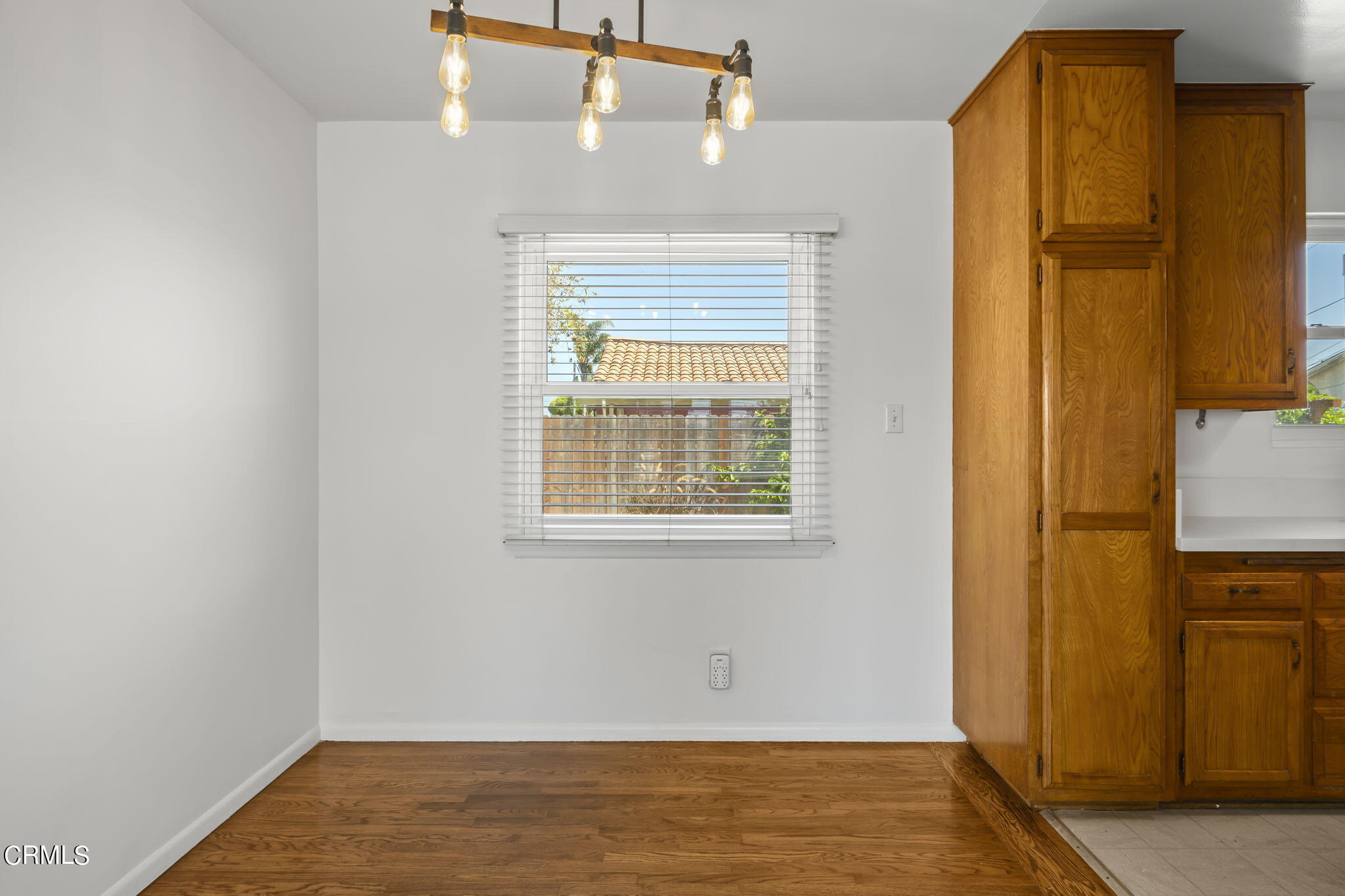 237 Brucker Road West Oxnard, CA 93033 - Photo 12 of 29 a view of an empty room with wooden floor and a window