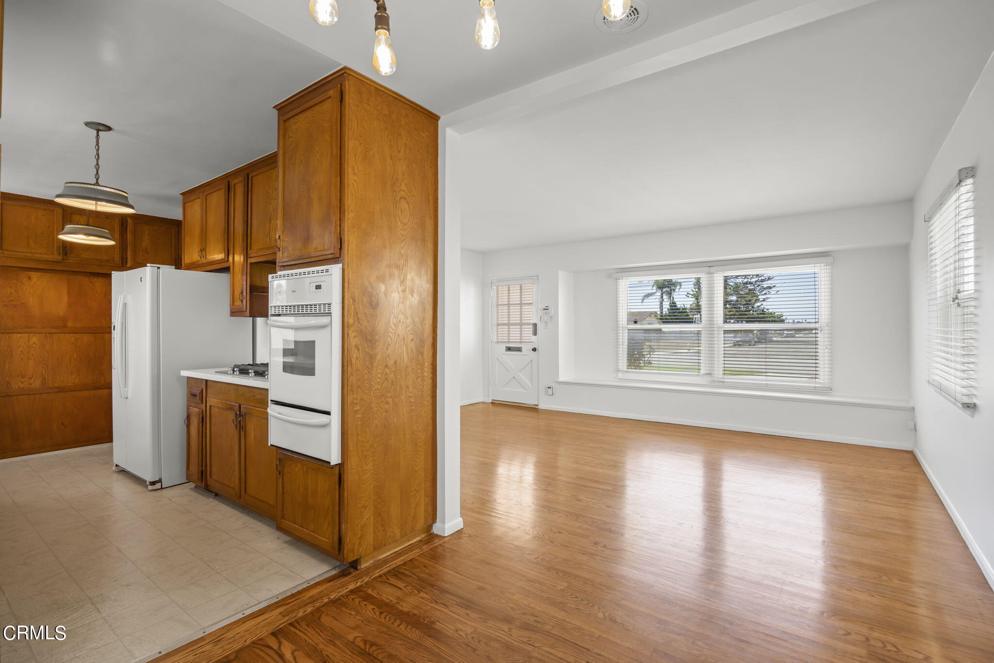 237 Brucker Road West Oxnard, CA 93033 - Photo 15 of 29 a kitchen with stainless steel appliances a refrigerator and wooden floor