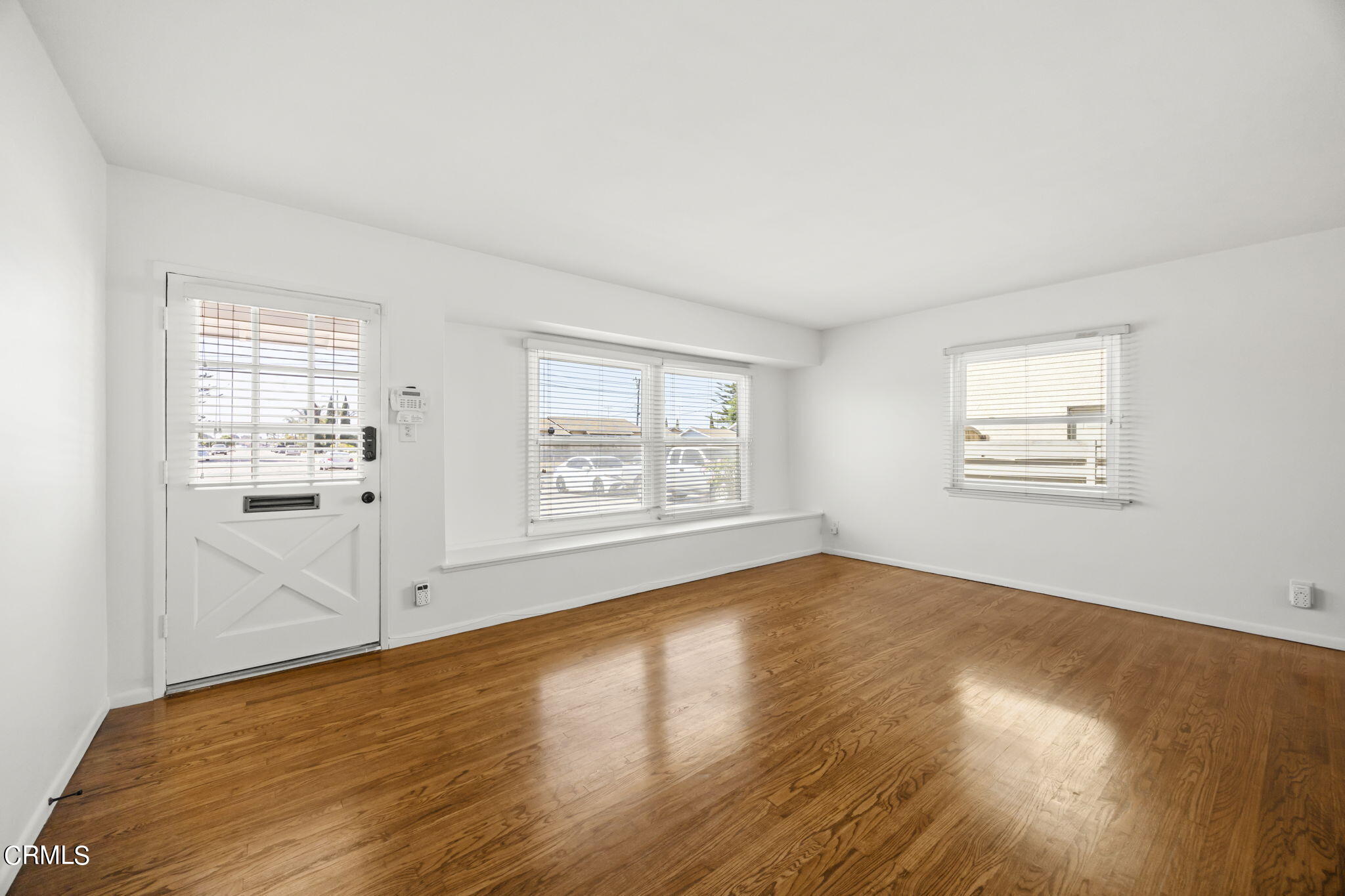 237 Brucker Road West Oxnard, CA 93033 - Photo 7 of 29 wooden floor in an empty room with a window