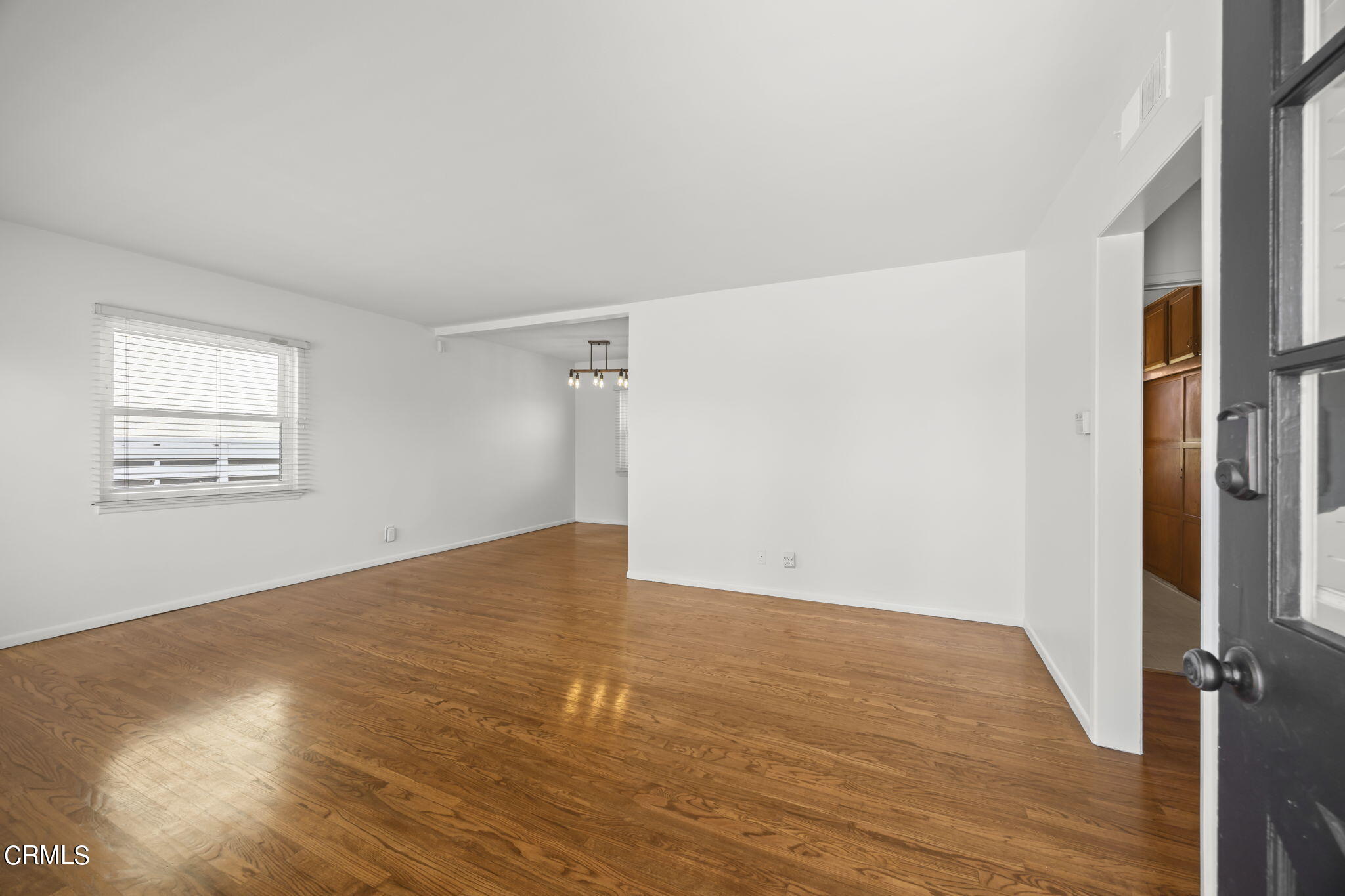 237 Brucker Road West Oxnard, CA 93033 - Photo 8 of 29 an empty room with wooden floor and windows