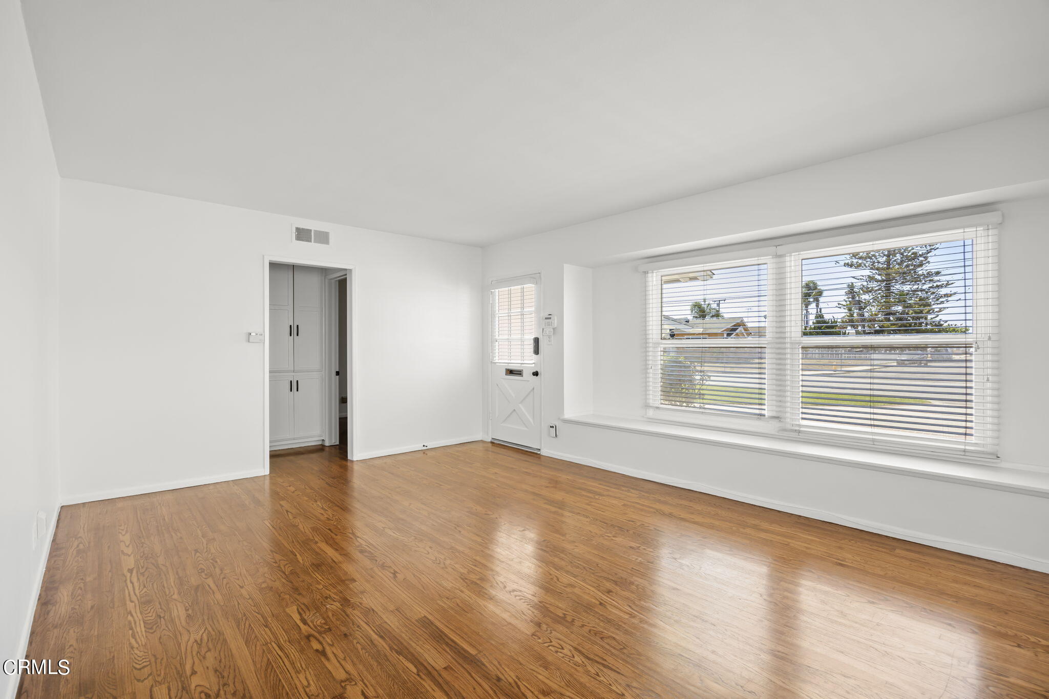 237 Brucker Road West Oxnard, CA 93033 - Photo 9 of 29 a view of an empty room with a window and wooden floor