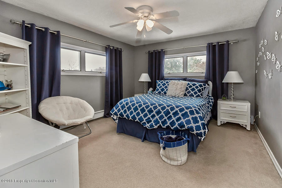 361 Upper Demunds Road Dallas, PA 18612 - Photo 15 of 27 a bedroom with a bed and a chandelier