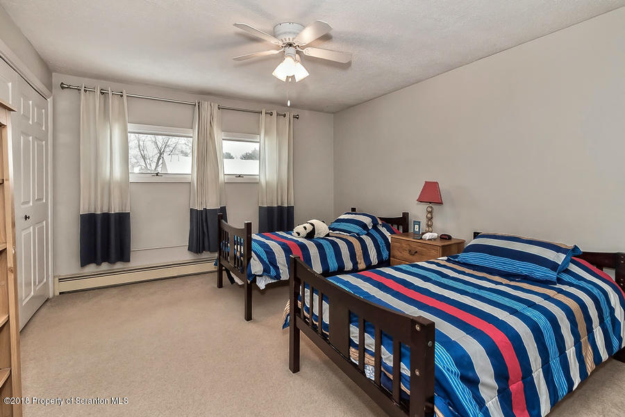 361 Upper Demunds Road Dallas, PA 18612 - Photo 16 of 27 a bedroom with two beds and a chandelier
