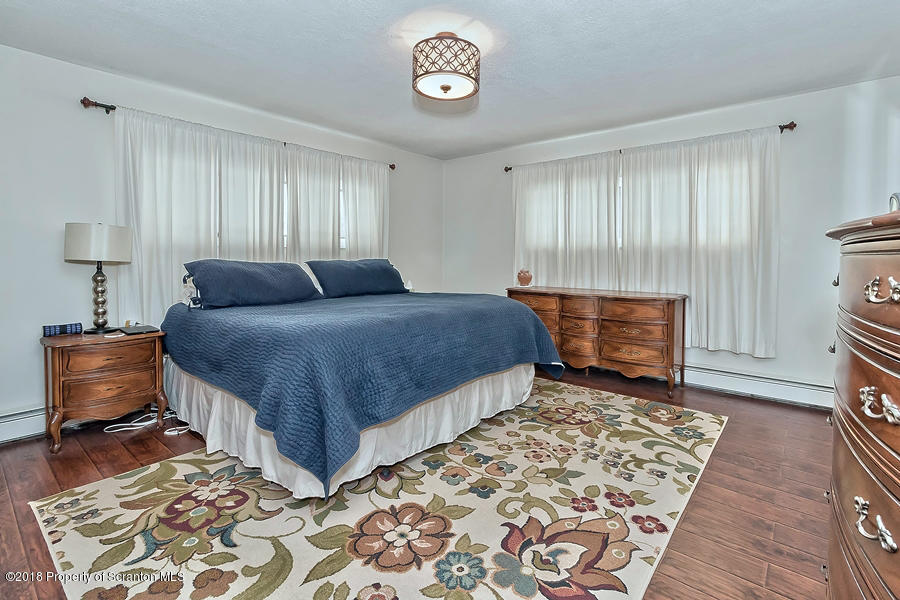 361 Upper Demunds Road Dallas, PA 18612 - Photo 19 of 27 a bedroom with a bed and a fireplace