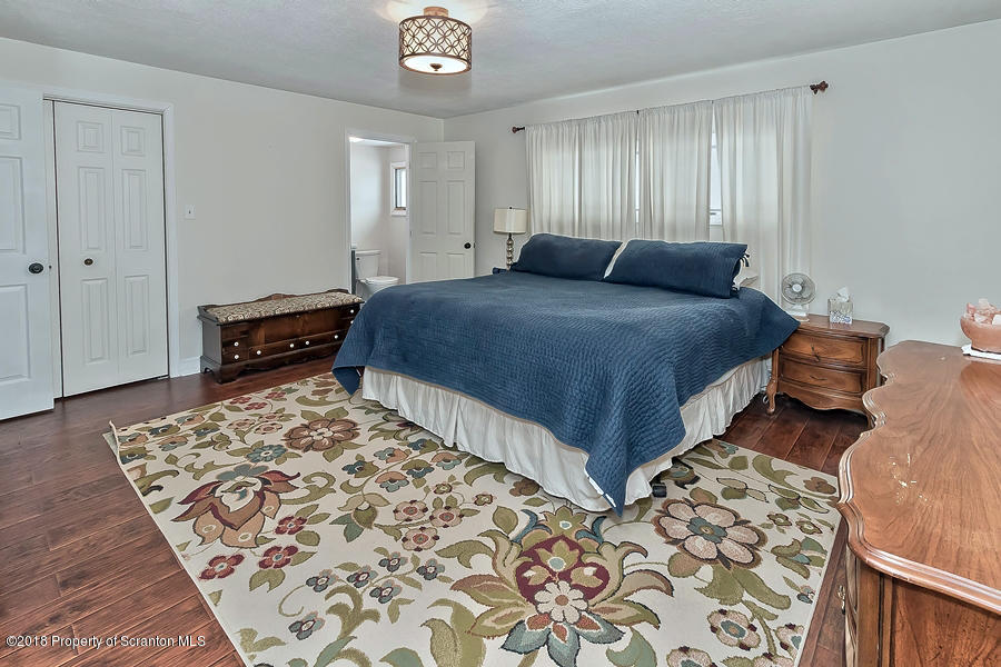 361 Upper Demunds Road Dallas, PA 18612 - Photo 20 of 27 a bedroom with bed and wooden floor
