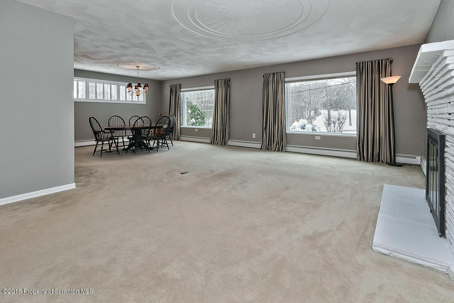 361 Upper Demunds Road Dallas, PA 18612 - Photo 2 of 27 a view of a livingroom with furniture and a flat screen tv