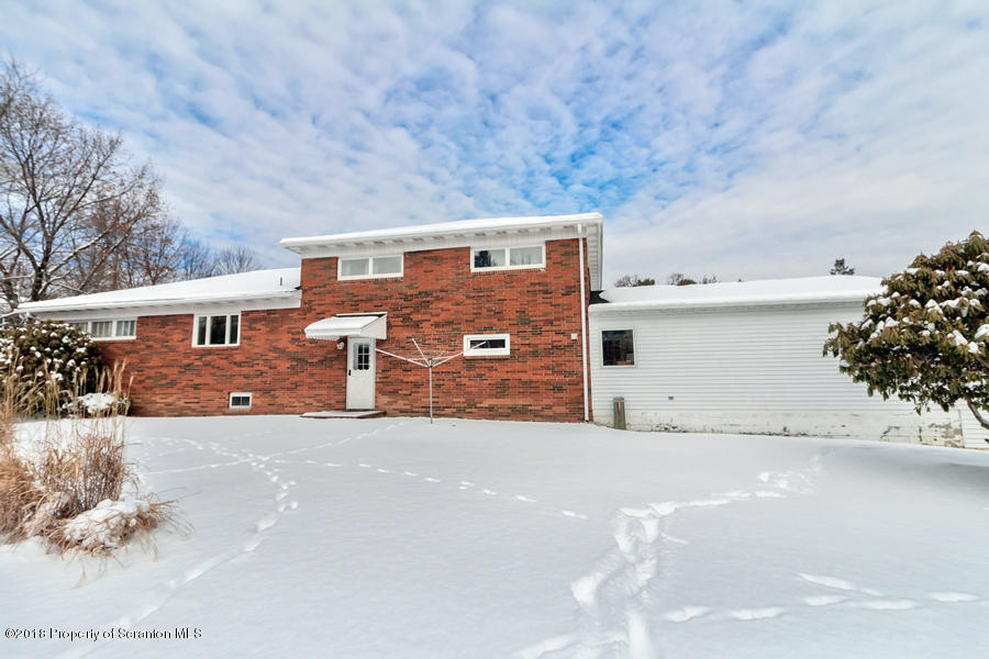 361 Upper Demunds Road Dallas, PA 18612 - Photo 25 of 27 a view of a house with a yard and garage