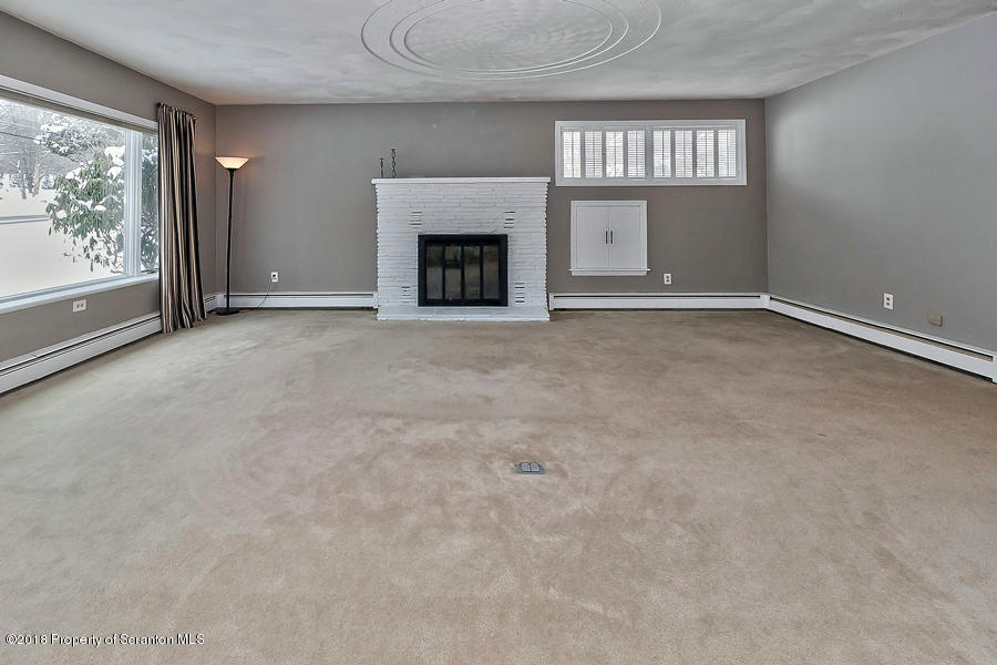 361 Upper Demunds Road Dallas, PA 18612 - Photo 3 of 27 an empty room with windows and fireplace