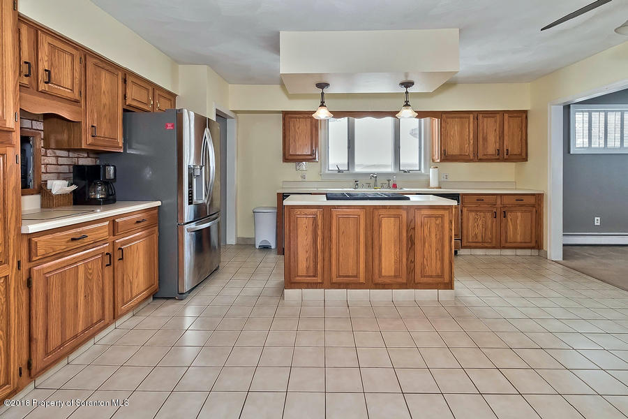 361 Upper Demunds Road Dallas, PA 18612 - Photo 7 of 27 a large kitchen with stainless steel appliances granite countertop a stove a sink dishwasher and a refrigerator