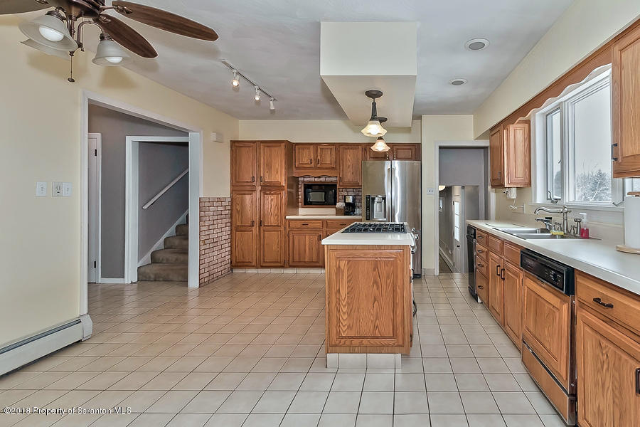 361 Upper Demunds Road Dallas, PA 18612 - Photo 8 of 27 a large kitchen with kitchen island a counter space a sink appliances and cabinets