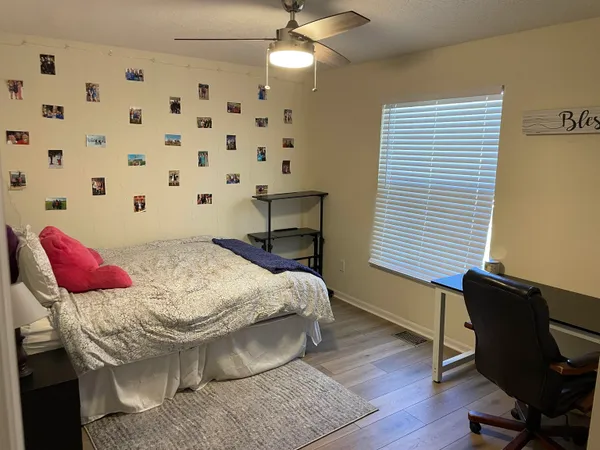a bedroom with a bed and a chandelier