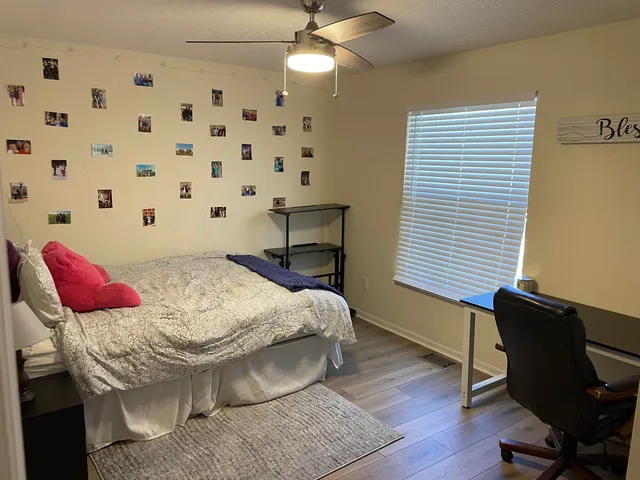 a bedroom with a bed and a chandelier