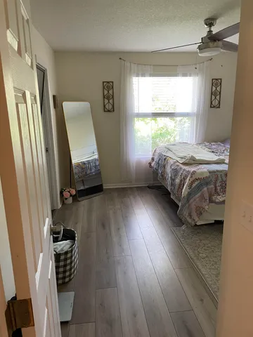 a bedroom with a bed and a window