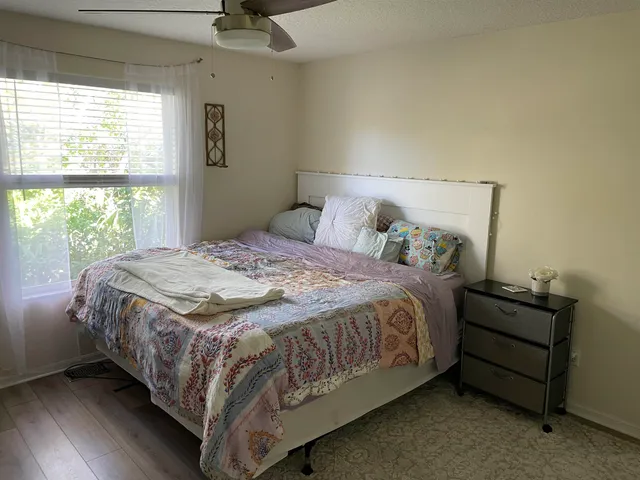 a bedroom with a bed and a window