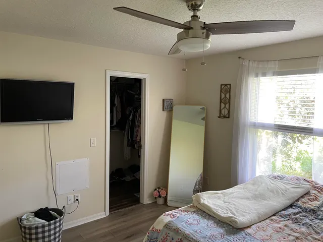 a bedroom with a bed and a flat tv screen