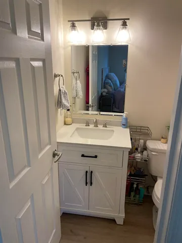 a bathroom with a sink vanity and a mirror