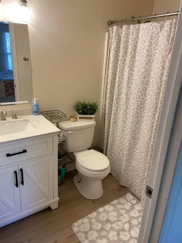 a bathroom with a sink toilet and shower