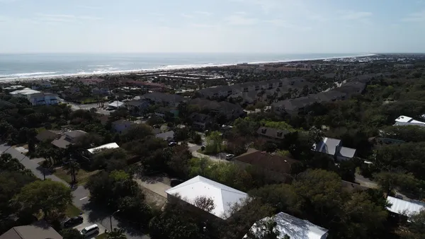 an aerial view of a residential houses with city view