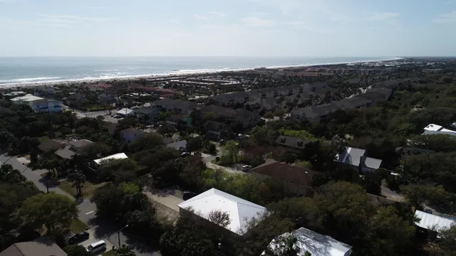 an aerial view of a residential houses with city view
