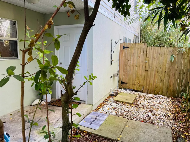 a balcony with glass top table and chairs