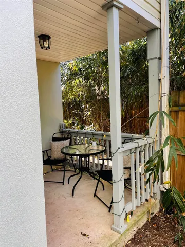 a view of a patio with table and chairs and potted plants