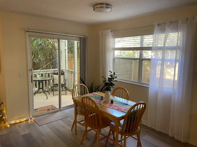 a view of a dining room with furniture window and outside view