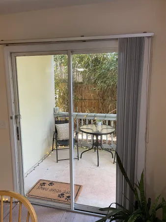 a view of a room with a table and chairs