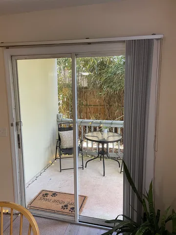 a view of a room with a table and chairs