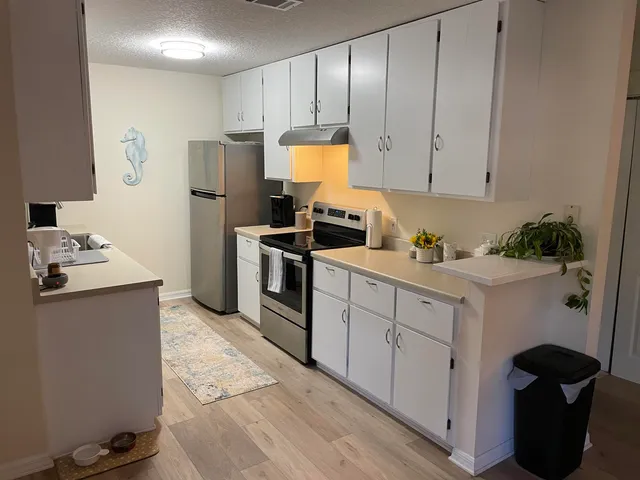 a kitchen with a sink cabinets and appliances