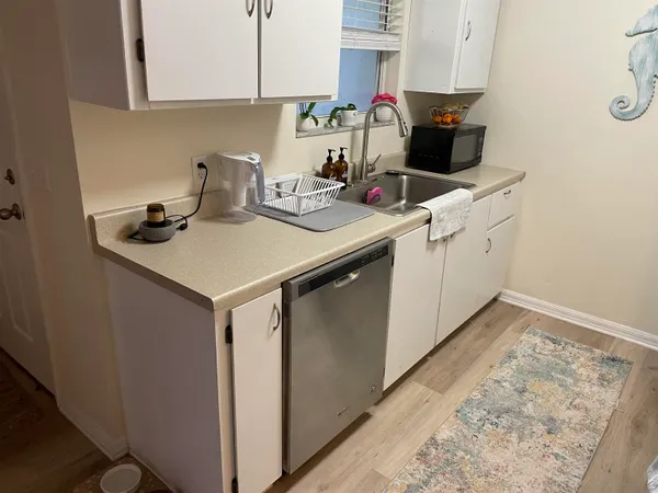 a kitchen with a sink cabinets and appliances