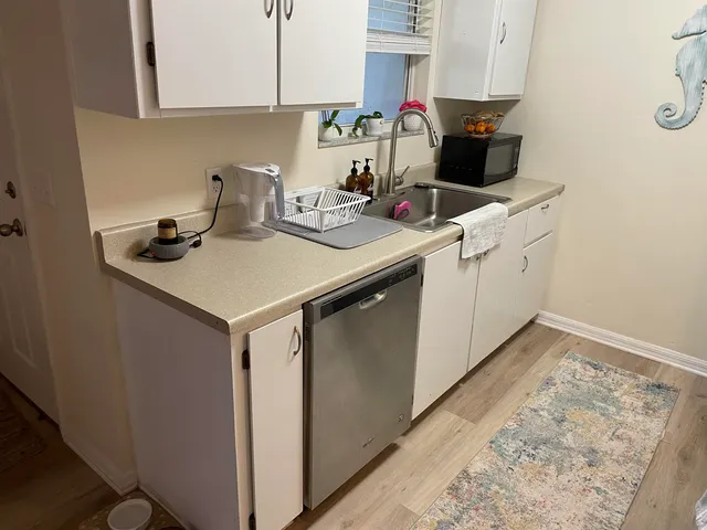 a kitchen with a sink cabinets and appliances