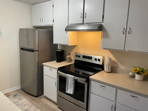 a kitchen with a stove and a refrigerator