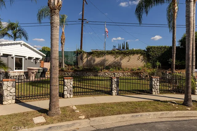 a view of a street with a small yard