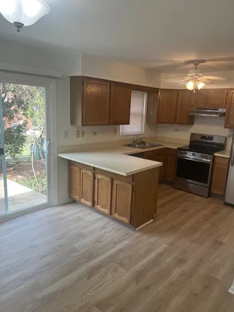 a kitchen with stainless steel appliances granite countertop a stove a sink and a refrigerator